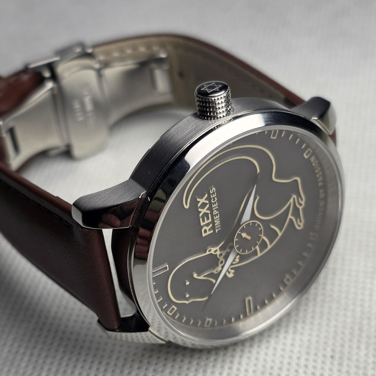 Angled view of the REXX dinosaur dial and engraved crown