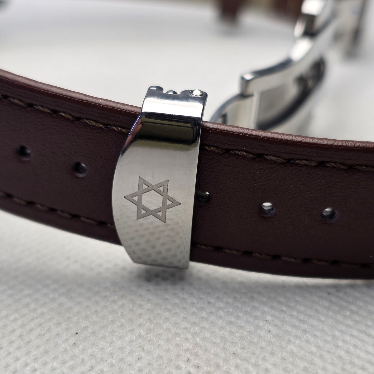 Brown leather strap and engraved butterfly clasp on the REXX Signature Piece