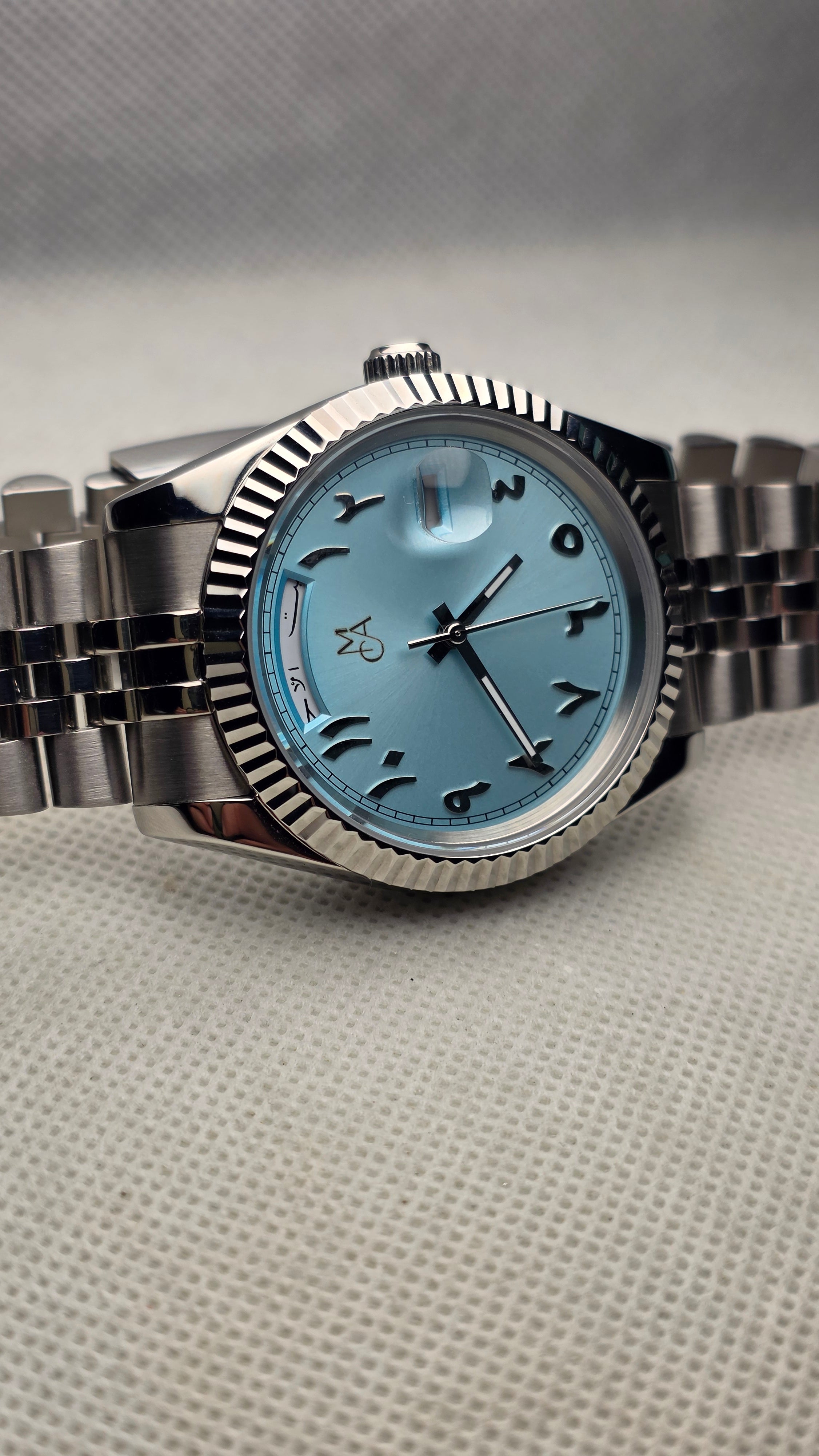 Aqua fluted custom watch with Hebrew numerals, a personal mark and steel bracelet