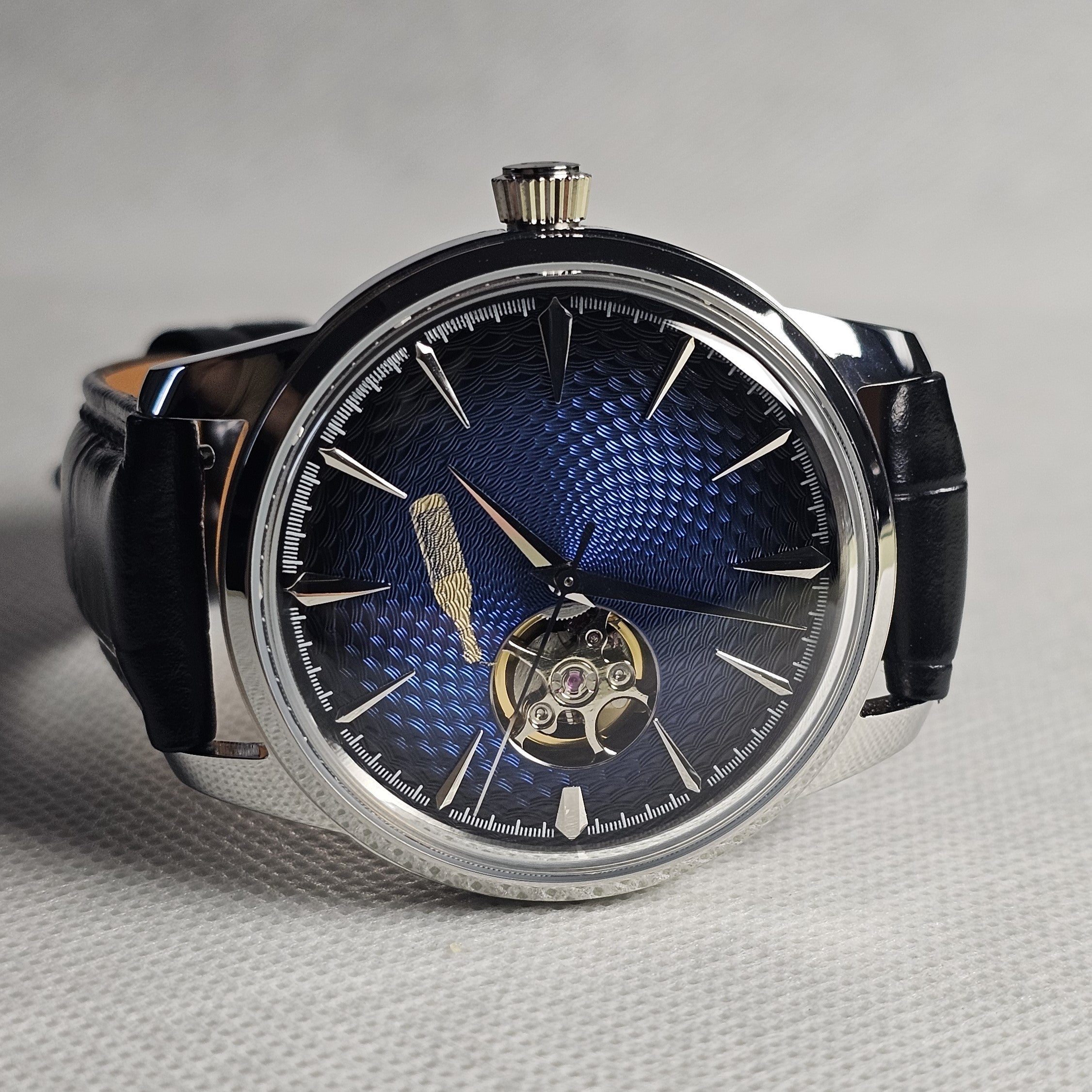 Blue textured open-heart custom dress watch in a polished steel case with a black leather strap