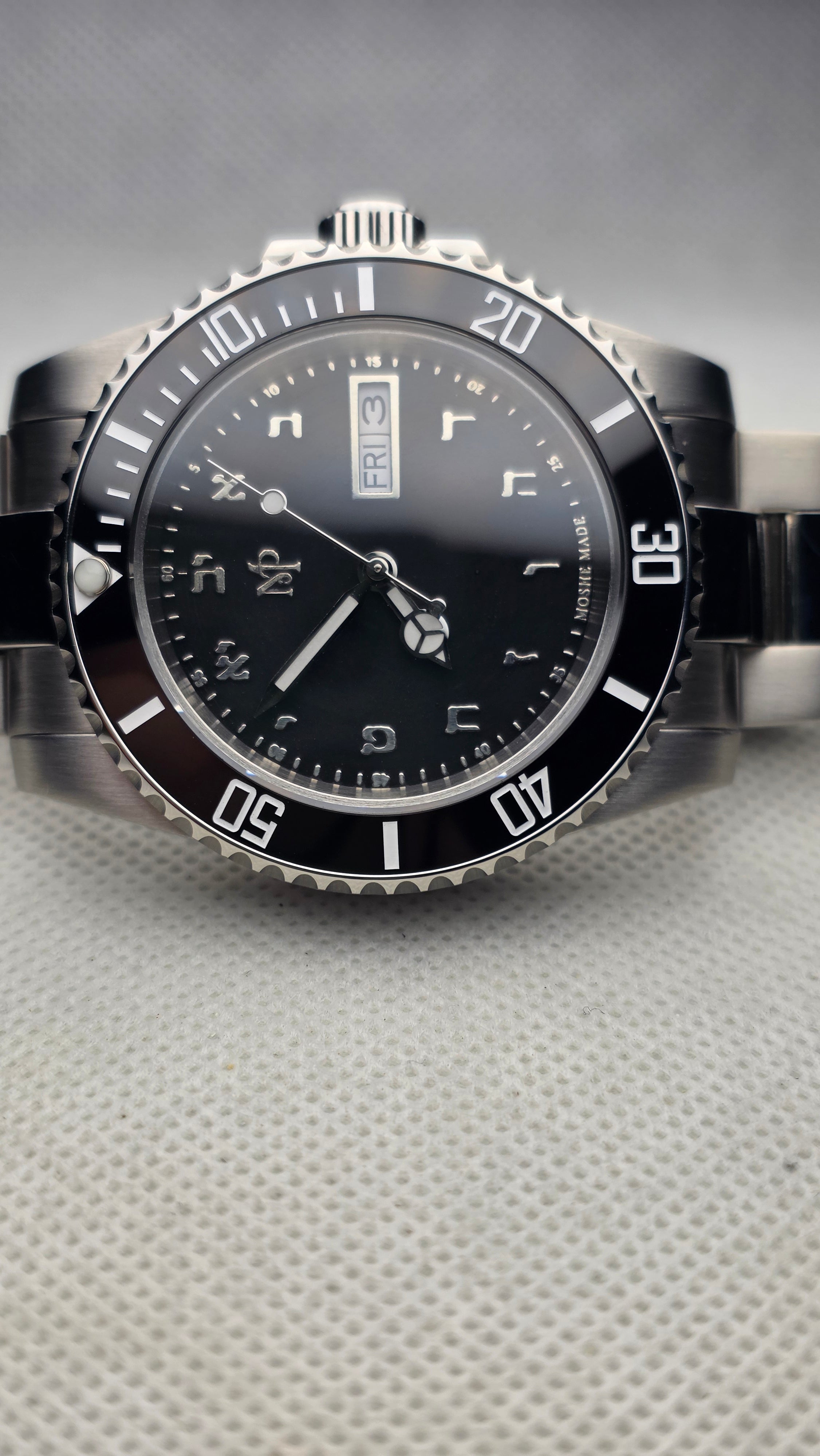 Black custom diver with engraved Hebrew numerals and a day-date display