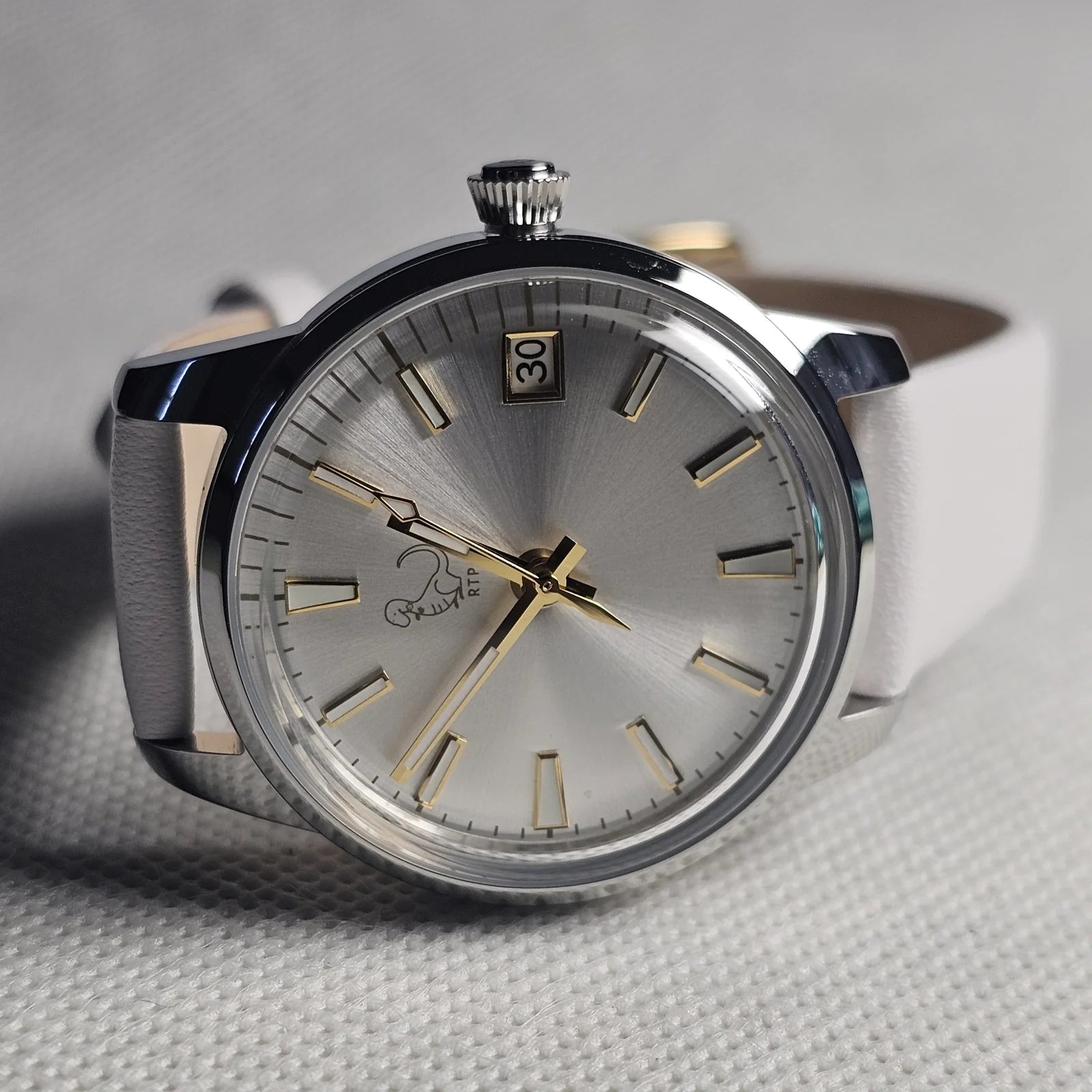Silver 33 millimetre custom watch with a cream dial and leather strap
