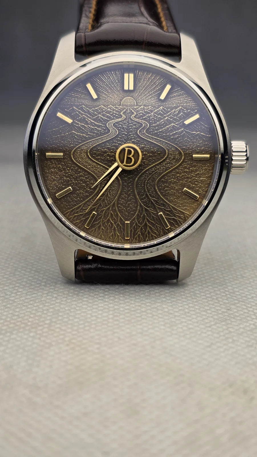 Black and gold engraved monogram watch