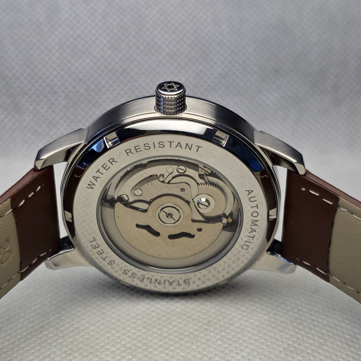 Exhibition caseback showing the NH35 automatic movement and engraved crown