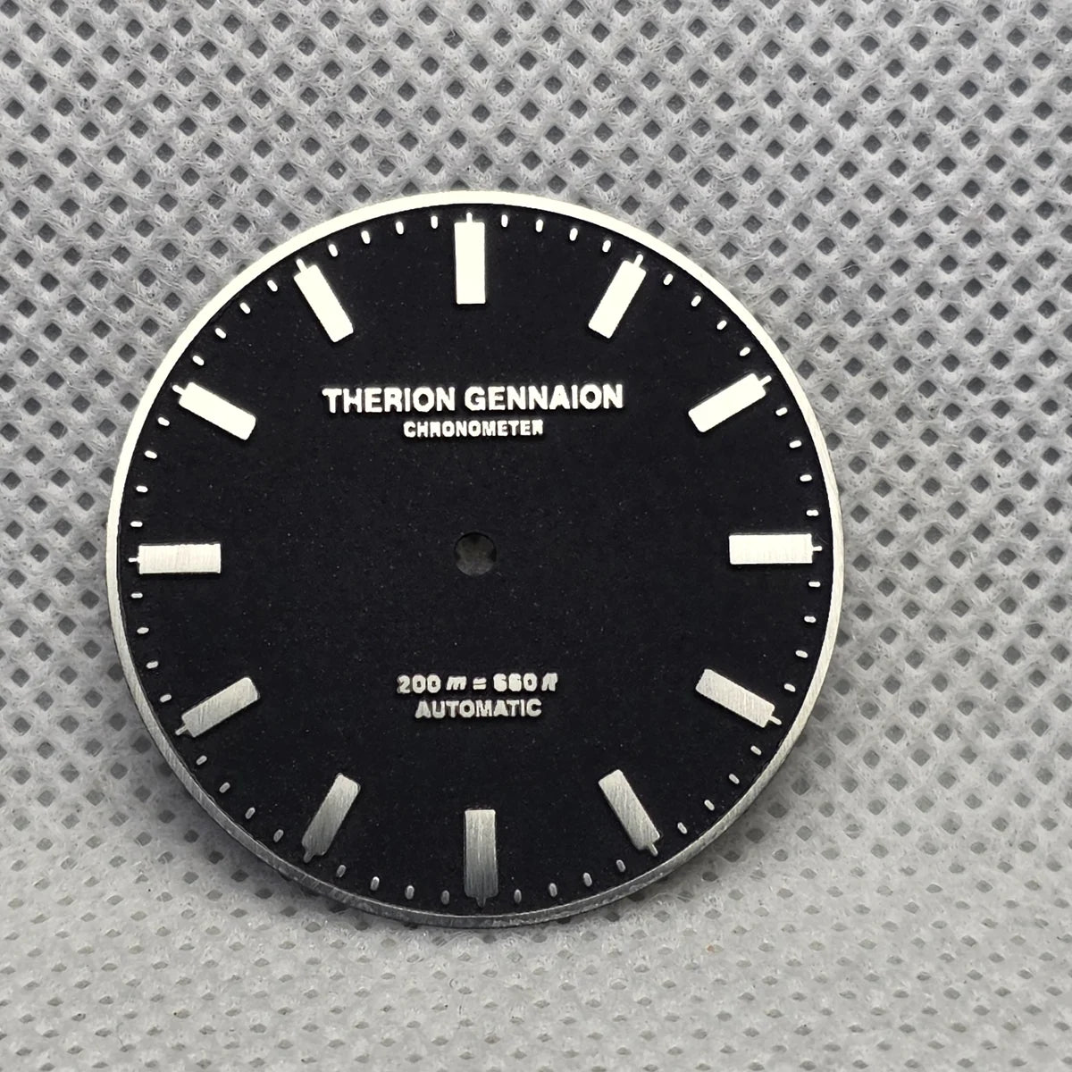 Black custom-text dial with raised silver-tone baton markers and lettering