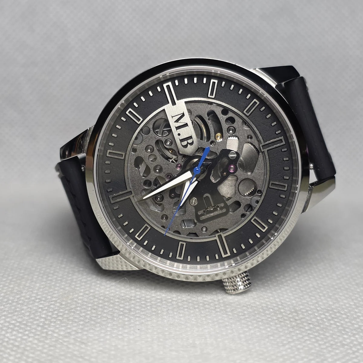 Custom watch with a black open-centre dial, exposed NH72 movement and blue seconds hand