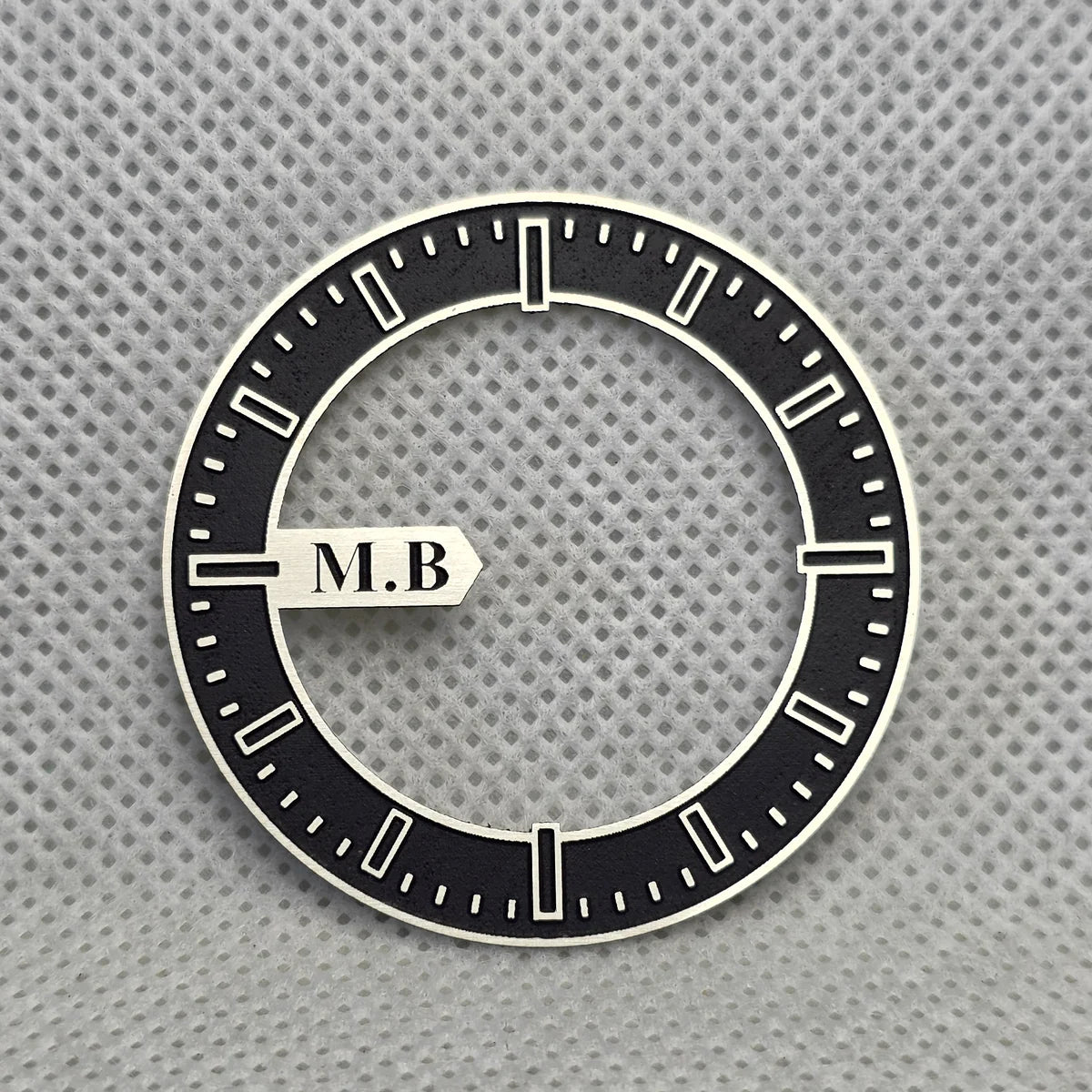 The black open-centre dial before assembly
