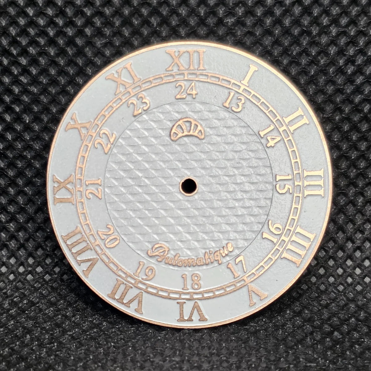 Warm rose-gold-tone custom dial with raised Roman numerals, an inner 24-hour track and textured centre